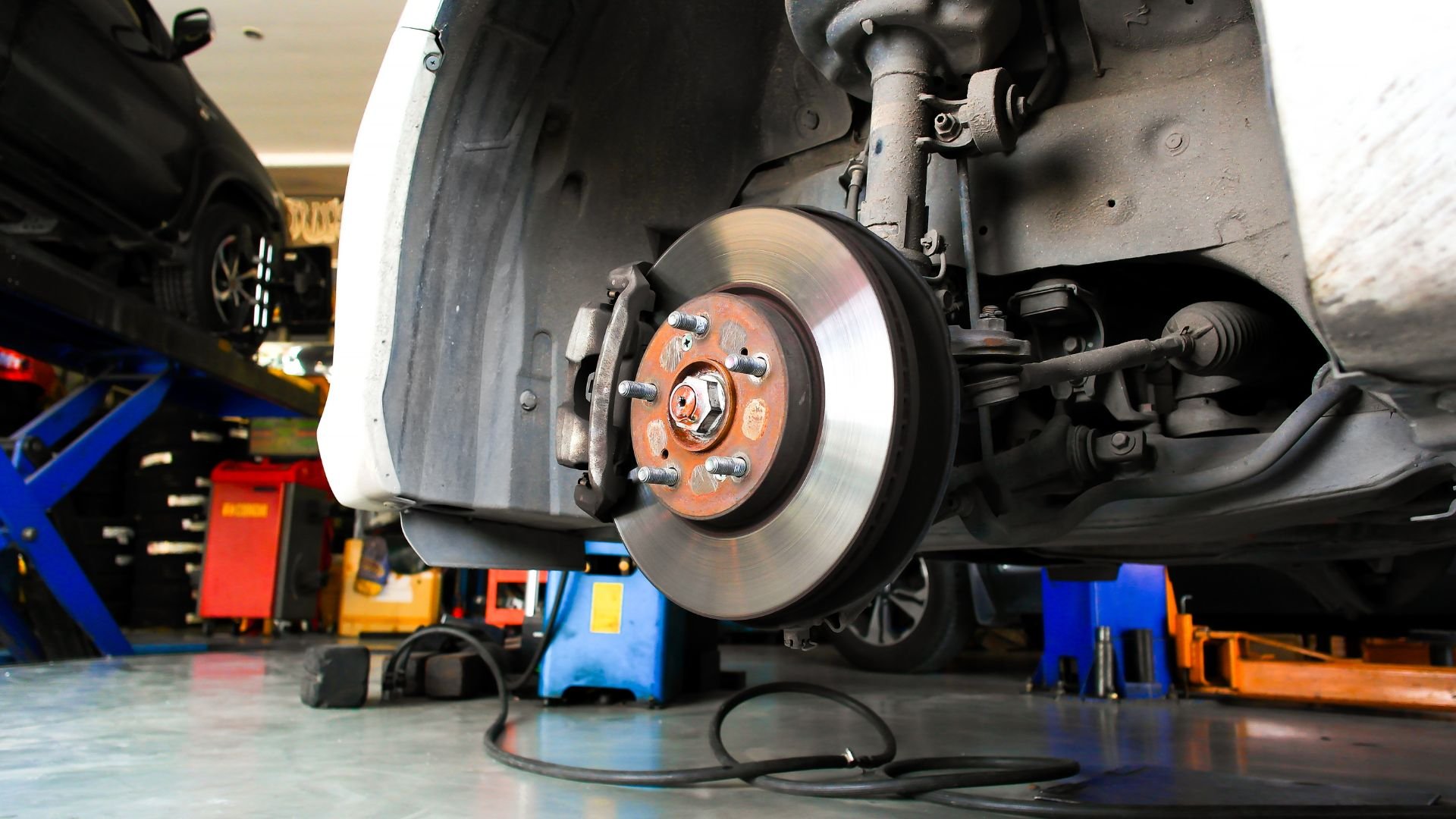 Car brake disc and suspension system in an auto repair shop